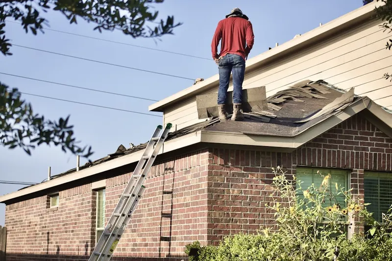 Professional roofer working on a residential roof in Indian Wells